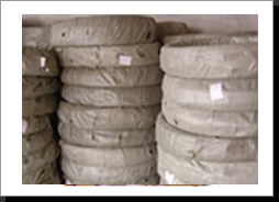 Barbed wire packed in rolls, wrapped with jute cloth or papers