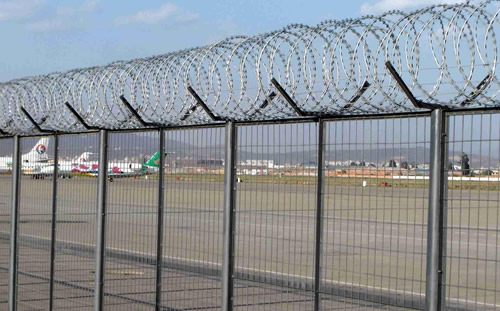 Air port fence with concertina coil razor wire